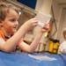Clayton Barde watches as a endothermic chemical reaction happens in his hands during Hot & Cold Chemistry, one of Ann Arbor Hands-On Museum's Hands-On Holidays: Hot vs. Cold exhibits Jan. 5. 
Courtney Sacco I AnnArbor.com   